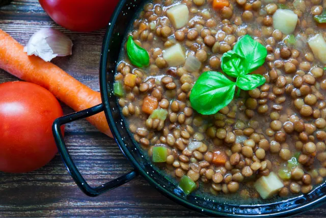 Photo showing a bowl of dal curry garnished with coriander leaves.